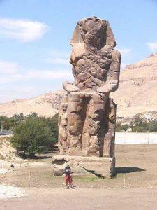 The Colossi of Memnon are two massive stone statues of