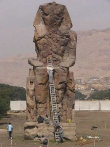 The Colossi of Memnon are two massive stone statues of