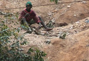 Lake Bunyonyi stone breakers break boulders into rocks into small