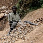 Lake Bunyonyi stone breakers break boulders into rocks into small