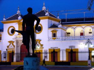 Seville in the evening outside the bullring with matador statue