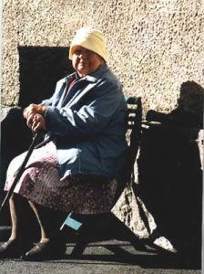 Old woman in autumn sun