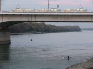 Rower quietly below and noisy tram