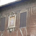 House with fading exterior frescos;  Rome has such a density