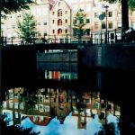 Amsterdam city view with waters reflection.