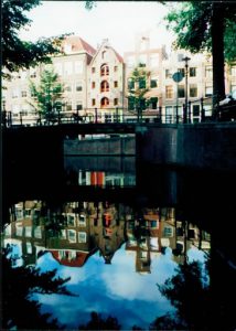 Amsterdam city view with waters reflection.