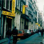 People walking next to a gay cinema.