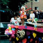 Bright and colorful hearts and balloons attached to another boat.