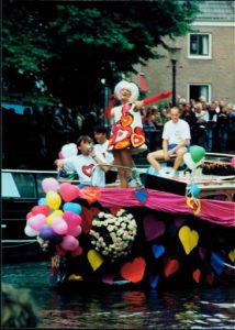 Bright and colorful hearts and balloons attached to another boat.