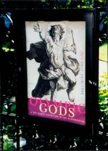 Olympic Gods poster hanging on a fence.