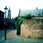 Street lantern with buildings in the distance.