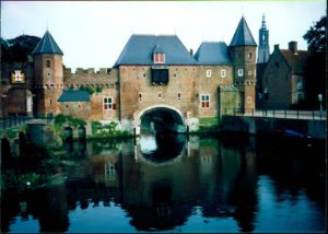 An old building with water passing below.