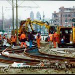 Construction workers repair railroad tracks.