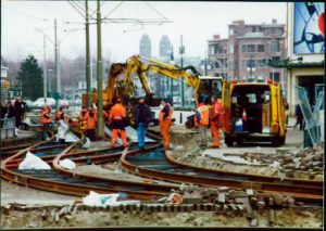 Construction workers repair railroad tracks.