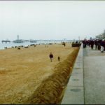 Street and beach of people walking.