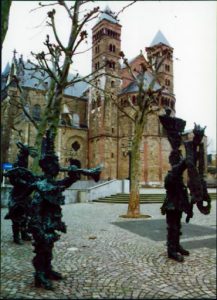 Statues standing in front of buildings.