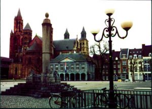 A street lantern, parked bicycles and buildings in the background.