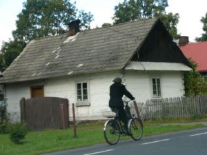 Man riding bike near houses