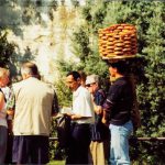 Tourists and local pretzel vendor.