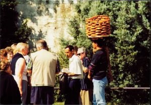 Tourists and local pretzel vendor.
