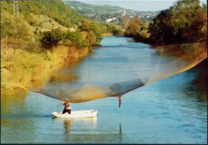 Fisherman casting net near the