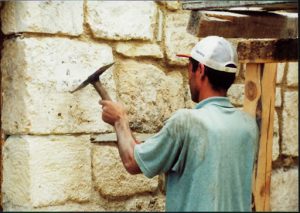 Stone carver chipping the volcanic stone