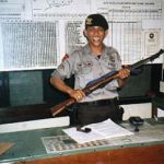 Proud policeman with gun