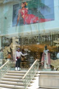 Fashionable upscale clothing store with guard/doorman.