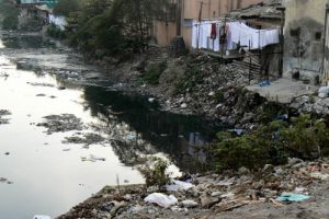 Squalid quarters along a filthy stream