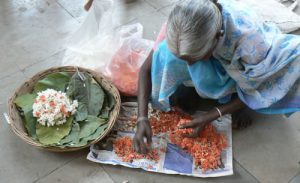 Making flower necklaces for sale.