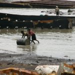 Pushing barrels of oil drained from