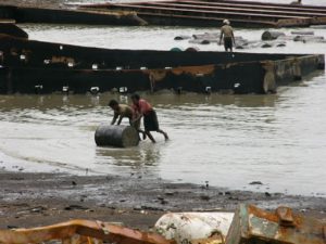 Pushing barrels of oil drained from