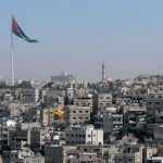 Amman - Jordanian flag over the city