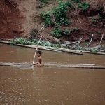 Rural girl on bamboo raft