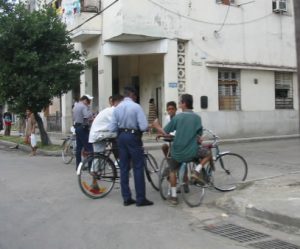 Police inspecting ID papers of teens (police on every corner)