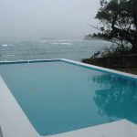 Swimming pool by the sea at Blue Harbour House