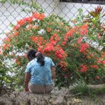 Woman sitting by flowers at Carolina