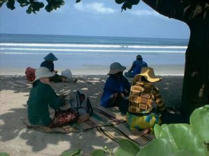 Indonesia - massage ladies on Kuta Beach waiting for customers.