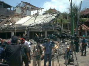 The wreckage at the bombsite with newspaper/TV