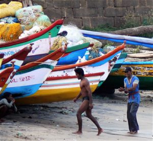 Kanyakumari - colorful fishing boats and a sinuous crew member.