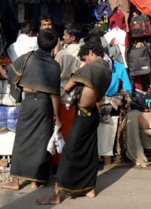Kanyakumari tourists browse the bazaars. Young pilgrims dressed in black.