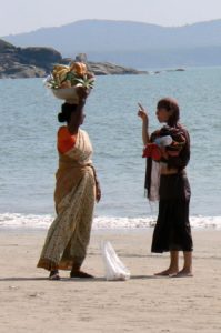 Fruit vendor and tourist at Palolem Beach