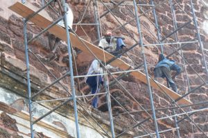 Workers restoring a church in Old