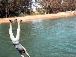 Diving fully clothed from the bridge.