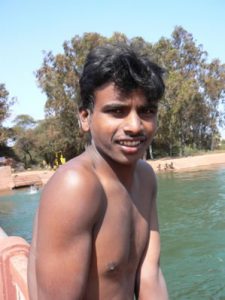 Kids diving and swimming from a bridge in Goa.