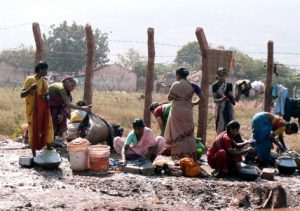 Women doing laundry at a watering