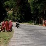 Women walking home from road repair work