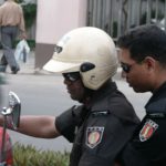 Dhaka - off-duty police on their way home via motorbike.