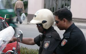 Dhaka - off-duty police on their way home via motorbike.