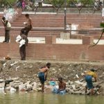Dhaka - bathing in a city pond.